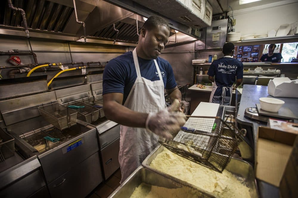 This is Anthony Anglin's second summer working the fryers at Moby Dick's in Wellfleet. He was already in the U.S. when the new rules went into effect and had many seasonal job offers. (Jesse Costa/WBUR)