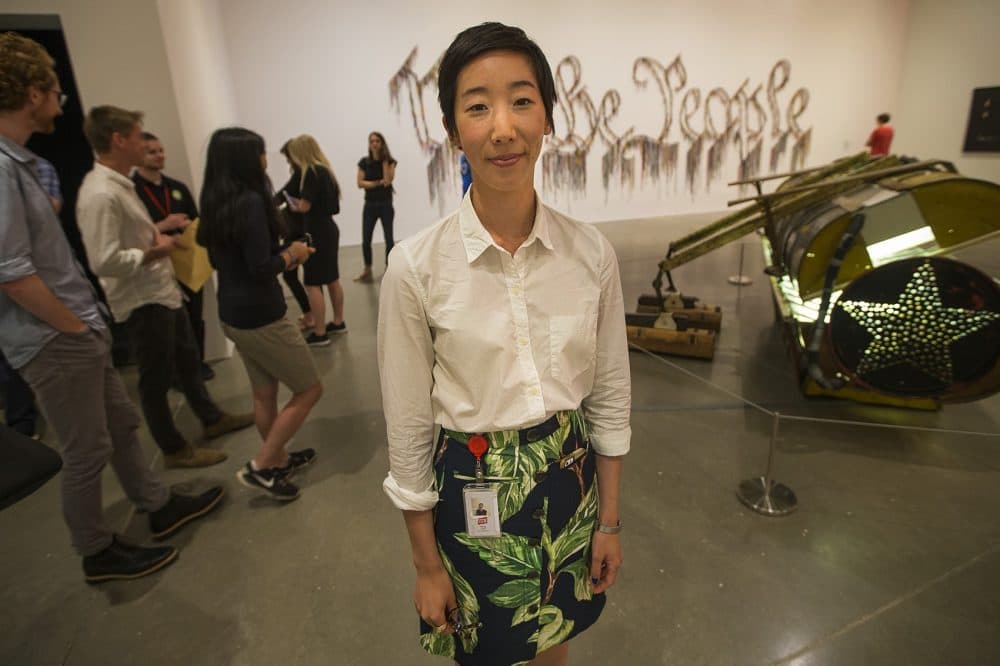 Jessica Hong, curatorial associate at the Institute of Contemporary Art in Boston standing in the Nari Ward exhibit. (Jesse Costa/WBUR)