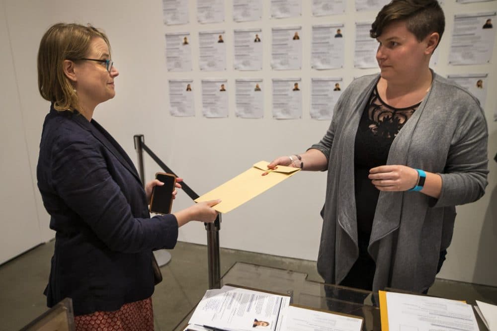 Goetschius receives her documentation as part of the interactive exhibit. (Jesse Costa/WBUR)