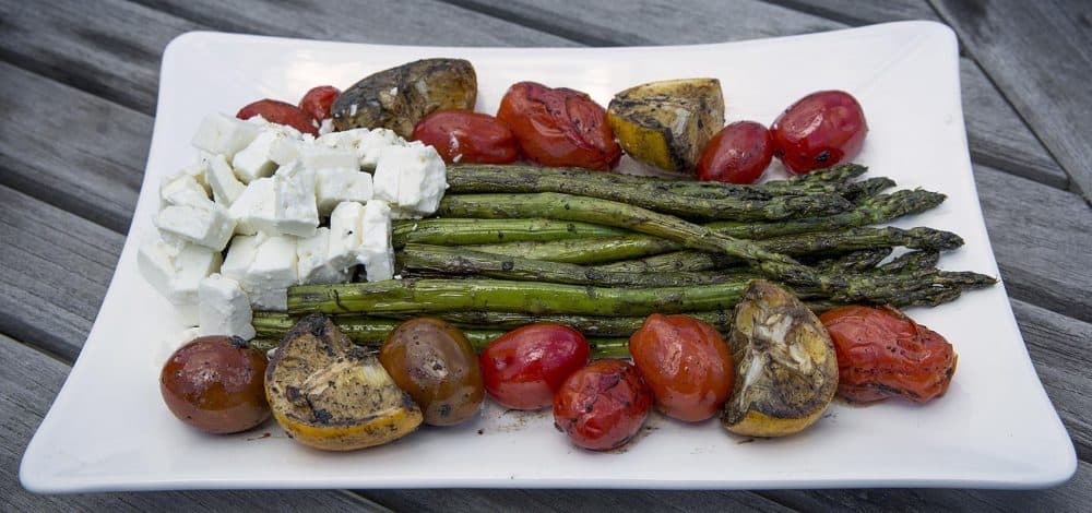 Kathy's grilled asparagus with grilled lemon, grilled tomatoes and feta cheese. (Robin Lubbock/WBUR)