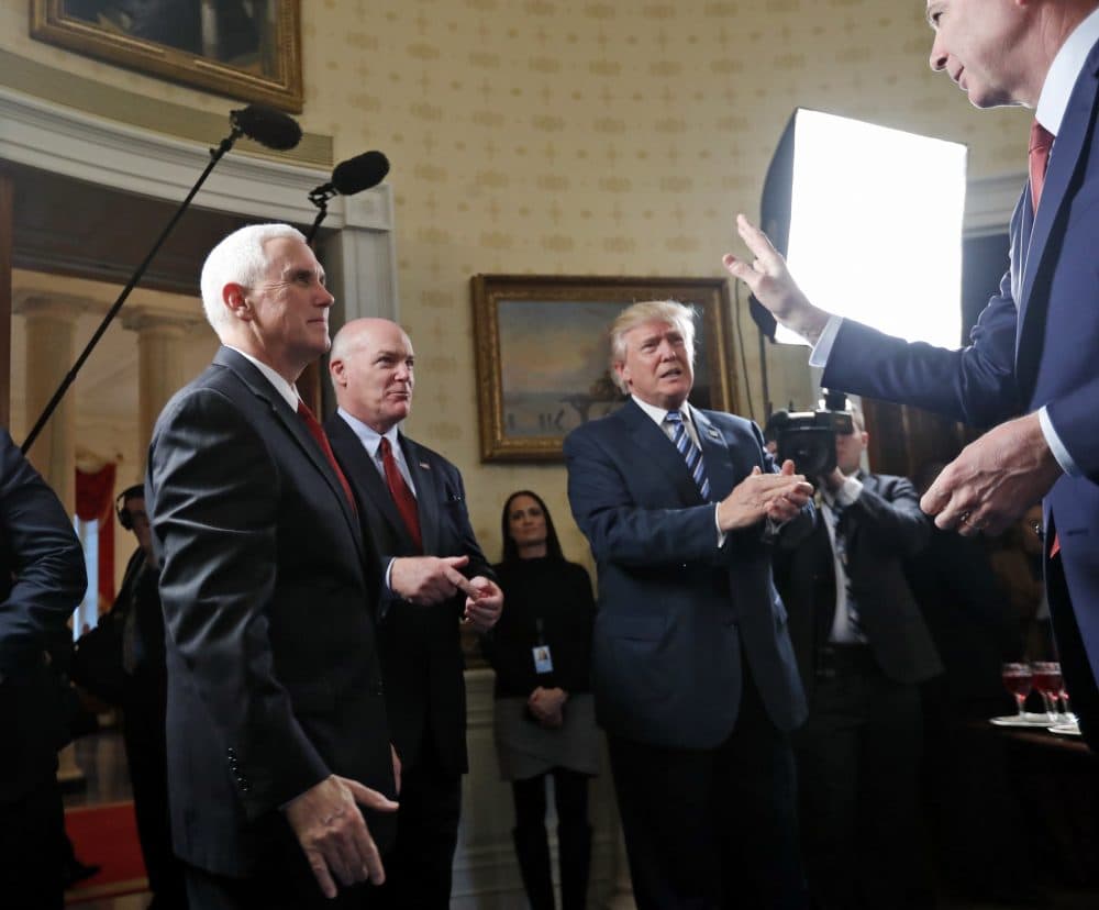 Vice President Mike Pence and Secret Service Director Joseph Clancy stand as President Trump applauds then-FBI Director James Comey, right, during a reception for inaugural law enforcement officers and first responders in the White House on Jan. 22, 2017. (Alex Brandon/AP)
