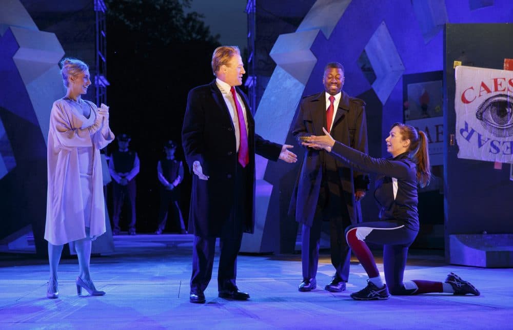 In this May 21, 2017 photo provided by The Public Theater, Tina Benko, left, portrays Melania Trump in the role of Caesar's wife, Calpurnia, and Gregg Henry, center left, portrays President Donald Trump in the role of Julius Caesar during a dress rehearsal of The Public Theater's Free Shakespeare in the Park production of Julius Caesar, in New York. Rounding out the cast on stage is Teagle F. Bougere as Casca, and Elizabeth Marvel, right, as Marc Anthony. (Joan Marcus/The Public Theater via AP)