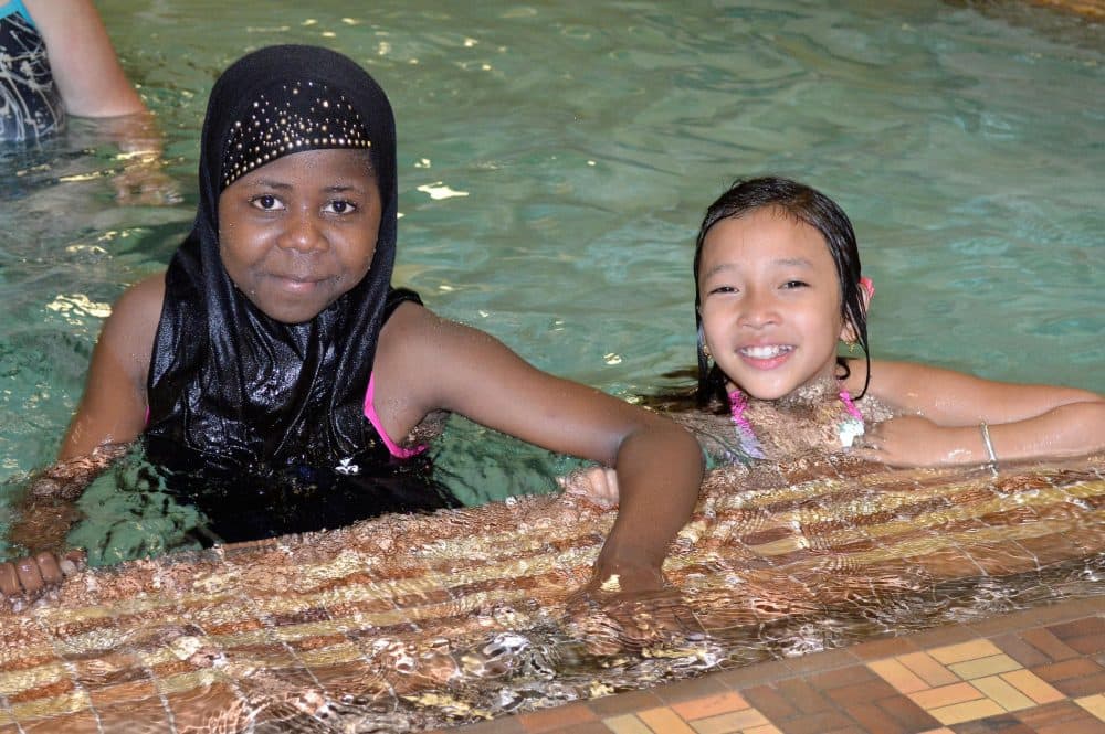 Sandra (right) says she got into the water for the first time in an after-school program. Back in Nepal and India, her family had never set foot in a swimming pool. (Courtesy Doug Bishop/YMCA)