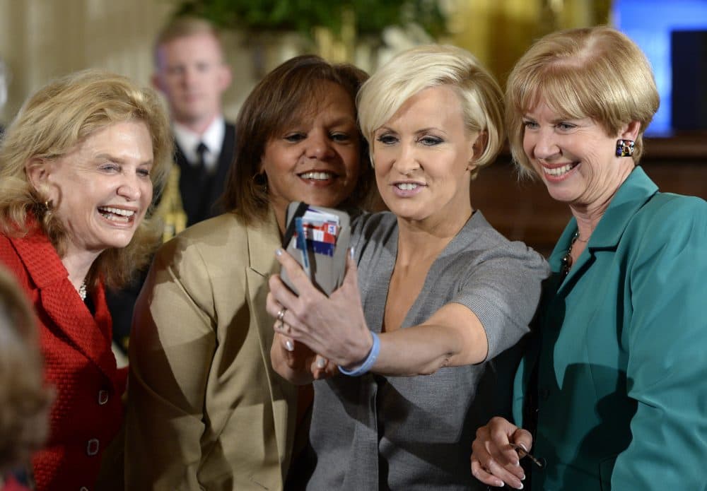 Rep. Carolyn Maloney, D-N.Y., left, and Morning Joe television host Mika Brzezinski, second from right, take a selfie with others in the East Room of the White House in Washington, April 2014. (Susan Walsh/AP)