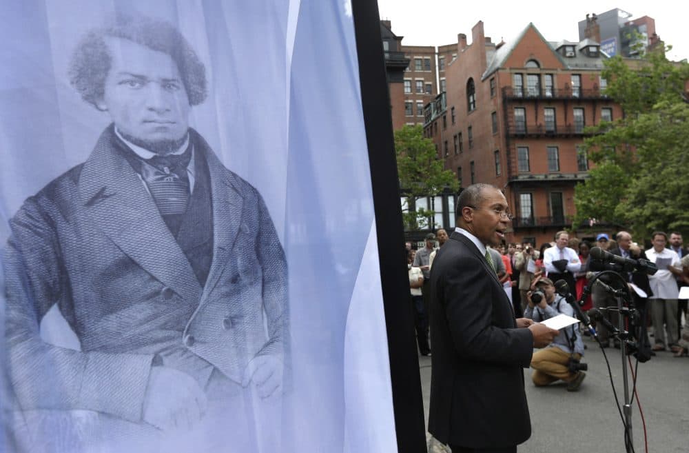 Former Massachusetts Gov. Deval Patrick stands next to a likeness of abolitionist leader Frederick Douglass while participating in a community reading of Douglass' speech on the Boston Common, July 2, 2013. (Steven Senne/AP)