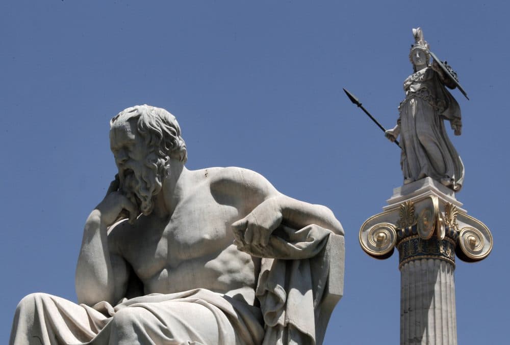 Pictured: The marble statue of Socrates in front of the Athens Academy and the statue of the ancient goddess Athena in Athens on June 5, 2012. (Dimitri Messinis/AP)