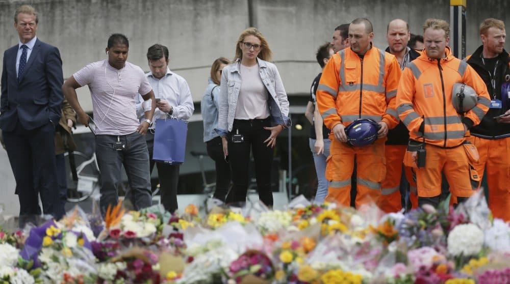 It’s a pressing question to consider, writes Justin Sinclair. Have we changed, and what are the consequences? Pictured: City workers and others stand after laying flower tributes in London for victims of the terrorist attack on London Bridge, on Monday, June 5, 2017. (Tim Ireland/AP)