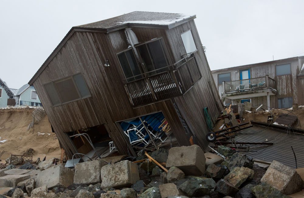 A partially collapsed home on Plum Island following a March 2013 storm (Jesse Costa/WBUR)