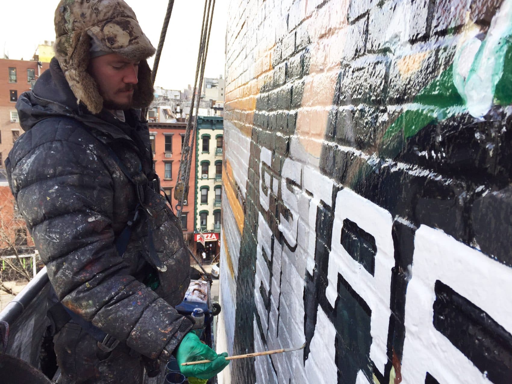 Liam McWilliams works on a hand-painted billboard in lower Manhattan. (Topher Forhecz)