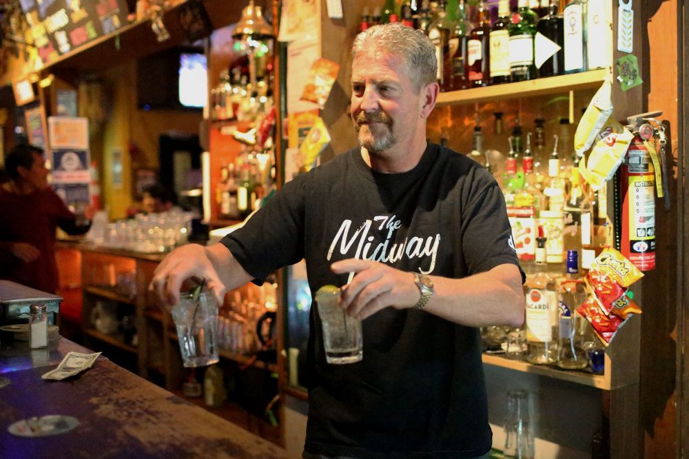 Midway Cafe owner Jay Balerna serves drinks. (Hadley Green for WBUR)