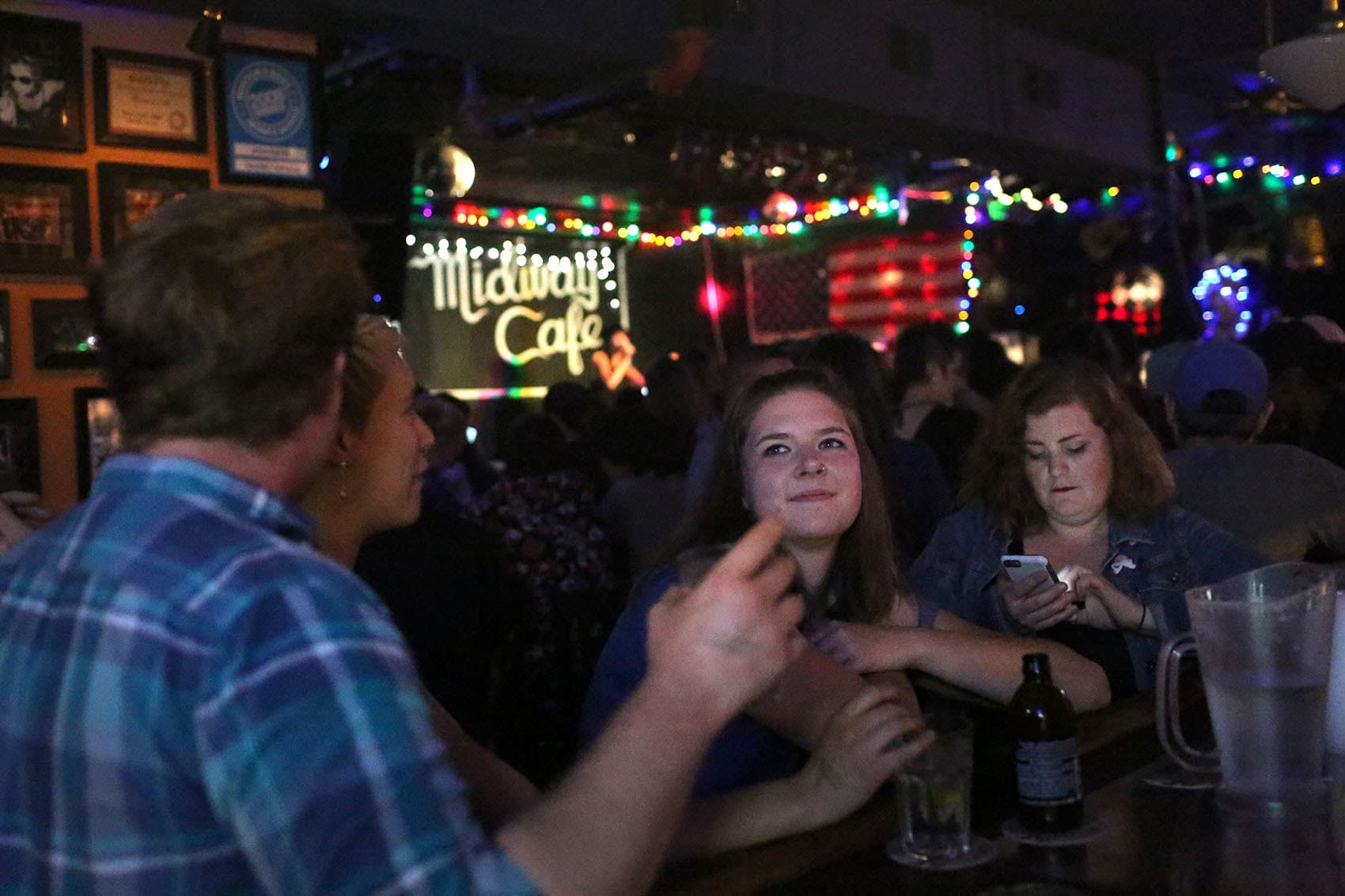 People sit at the Midway Cafe's bar. (Hadley Green for WBUR)