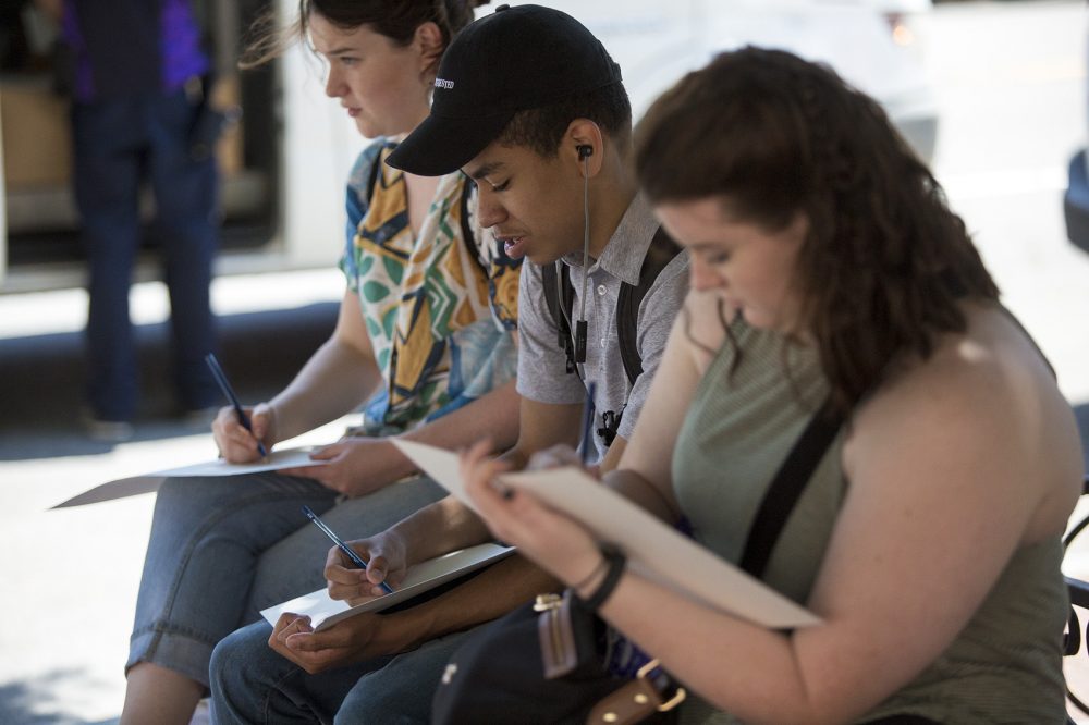 Claire Morris, Mikael Cesar and Heather Trites do basic sketches of the tree and border in front of the Cyclorama. (Jesse Costa/WBUR)