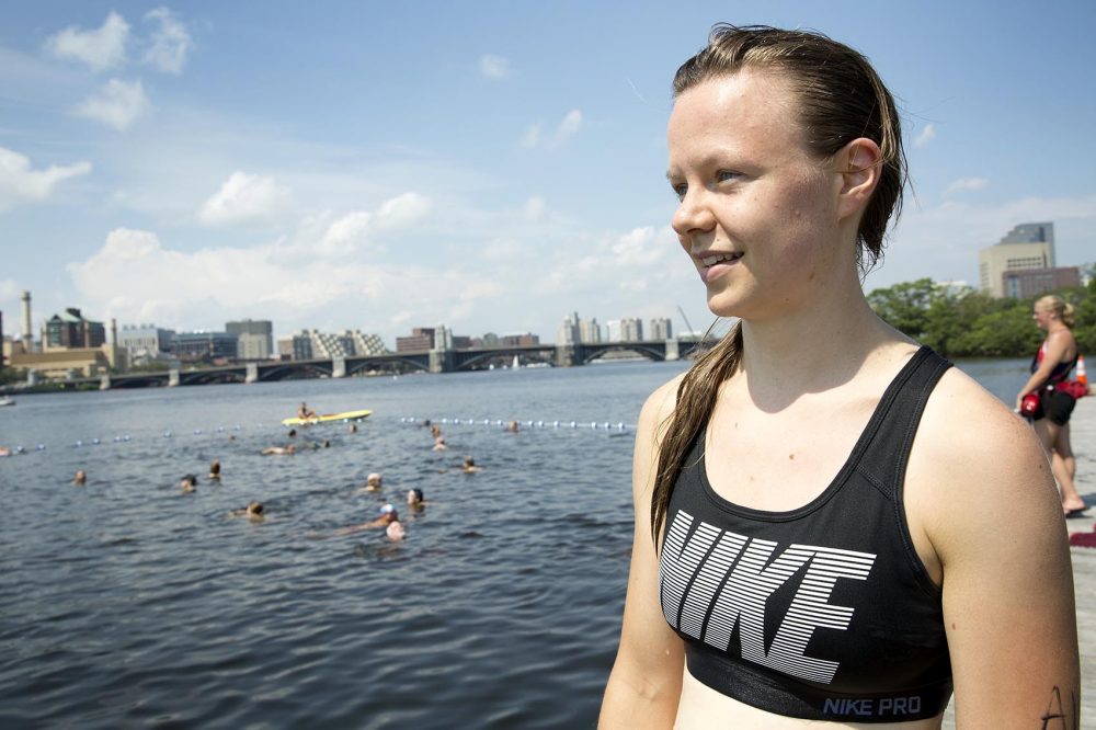 Lucie McCormick takes a break from her run for a swim in the Charles. (Robin Lubbock/WBUR)