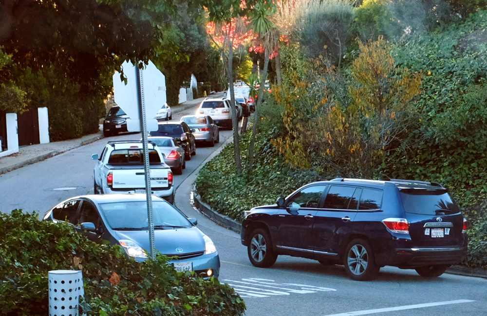 Early morning rush-hour traffic winds its way along a narrow street in the Sherman Oaks section of Los Angeles in 2014. When the people whose houses hug the narrow warren of streets paralleling the busiest urban freeway in America began to see bumper-to-bumper traffic rushing by their homes, they were baffled. When word spread that the explosively popular smartphone app Waze was sending many of those cars through their neighborhood in a quest to shave five minutes off a daily rush-hour commute, they were angry and ready to fight back. (Richard Vogel/AP)