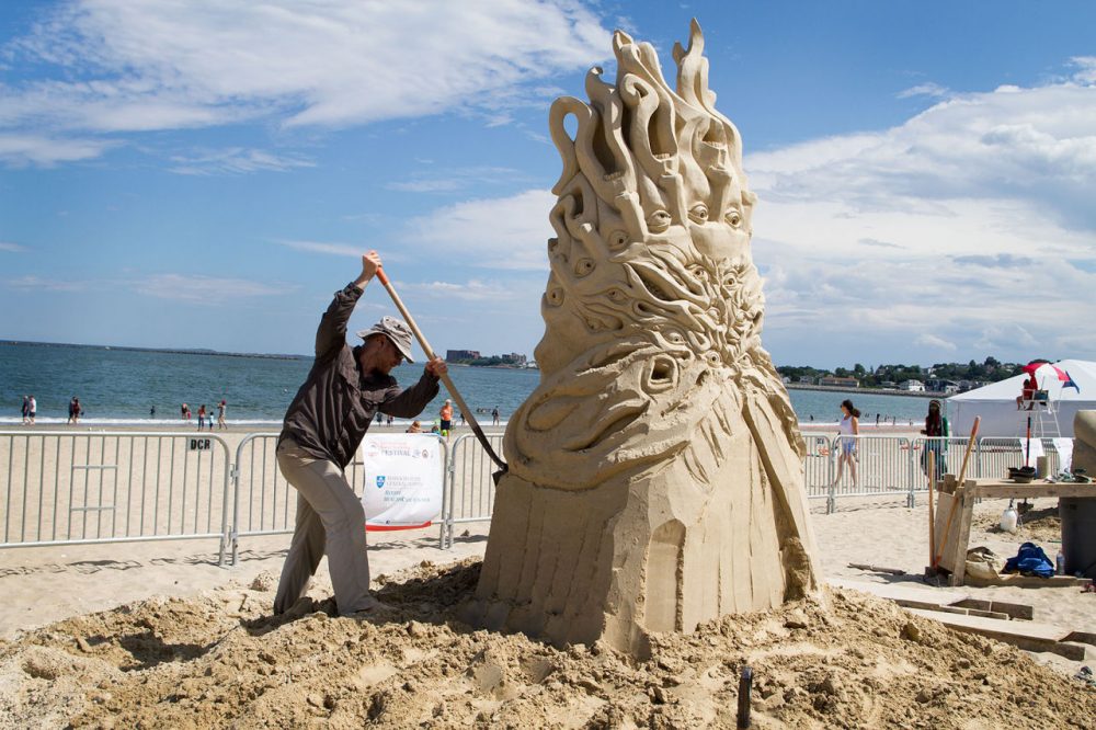Guy Olivier Deveau from Montreal works on his sculpture on Revere Beach in 2015. (Hadley Green for WBUR)
