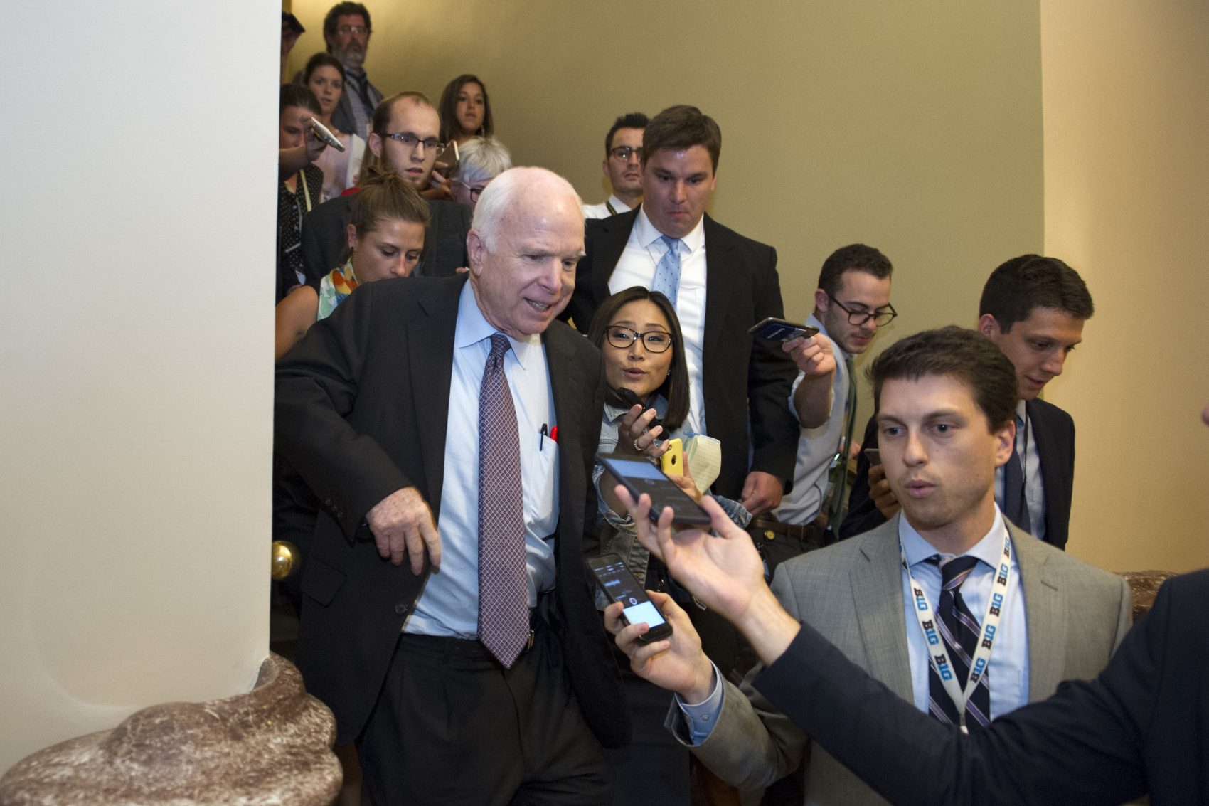 Sen. John McCain, R-Az., front left, is pursued by reporters after casting a "no" vote on a measure to repeal parts of former President Barack Obama's health care law, on Capitol Hill in Washington, Friday, July 28, 2017. (Cliff Owen/AP)