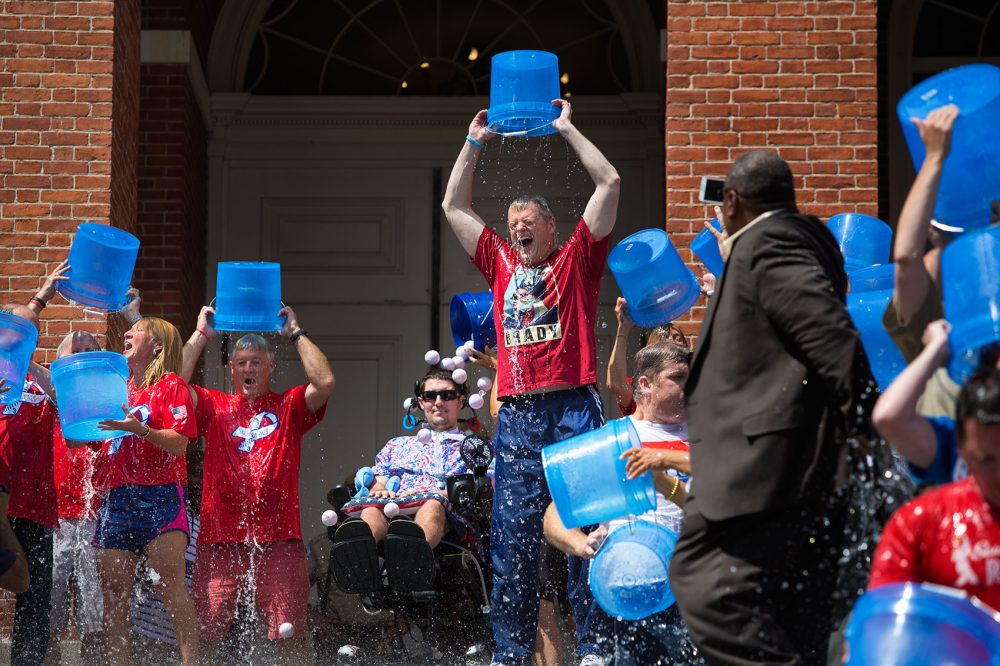 With Frates looking on, Gov. Charlie Baker and others take the ALS Ice Bucket Challenge on Aug. 10, 2015, on the State House steps. (Jesse Costa/WBUR)