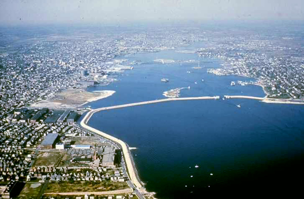 An aerial view of a section of the New Bedford hurricane barrier. The barrier rises 20 feet above the surface of the water, totals 3.5 miles in length, and crosses New Bedford and Fairhaven harbors. (US Army Corps of Engineers)