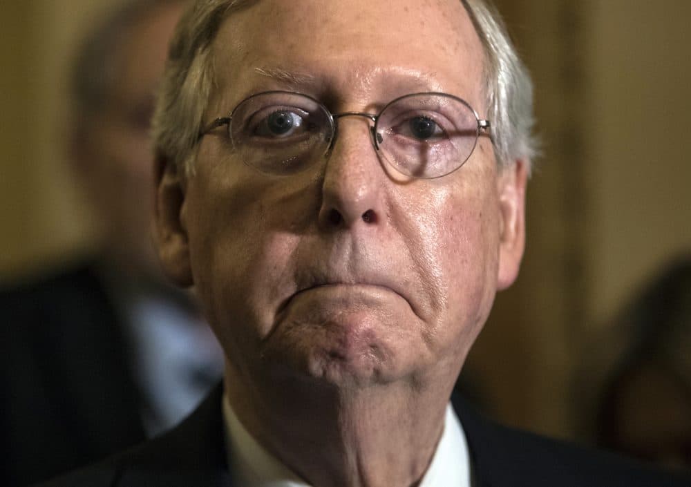 In this June 27 photo, Senate Majority Leader Mitch McConnell, R-Ky., tells reporters he is delaying a vote on the Republican health care bill. (J. Scott Applewhite/AP)