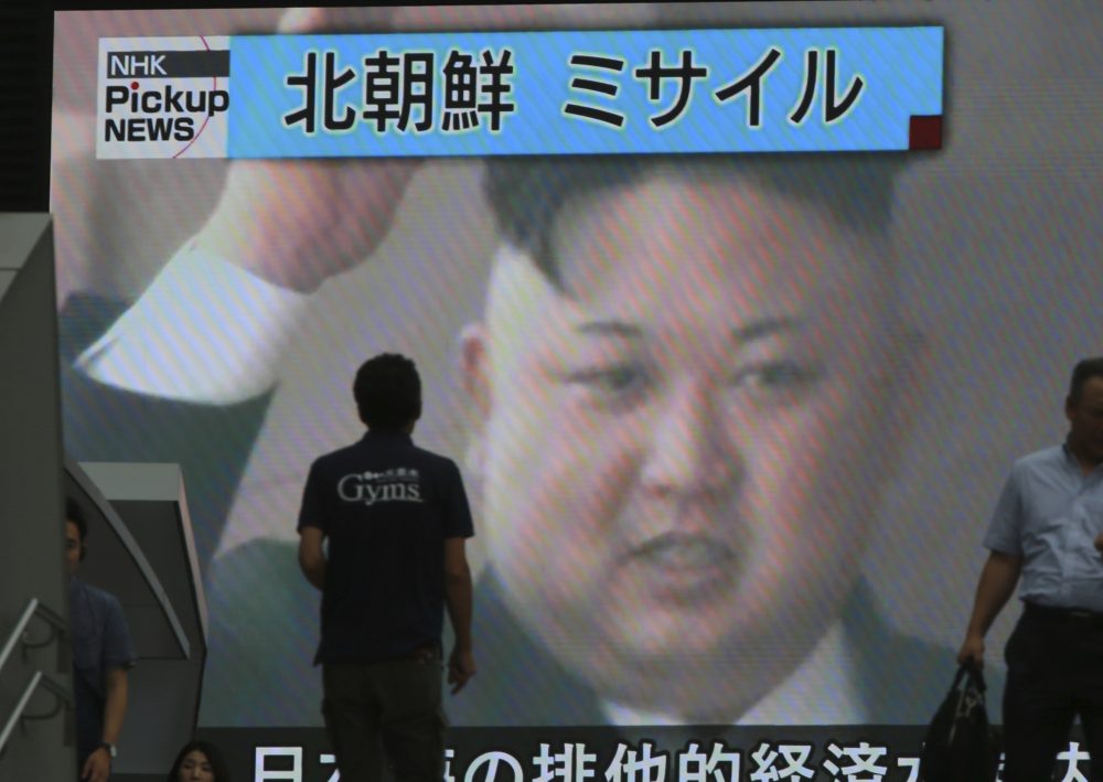 In this Tuesday, July 4, 2017 photo, people walk in front of an image of North Korean leader Kim Jong Un shown on a large screen as a TV news reports the North Korea's missile test which landed in the waters of Japan's economic zone, in Tokyo. Despite U.S. President Donald Trump's hopes for China's help in dealing with North Korea and his recent tough talk on the matter, the two sides seem to be growing further apart as their approaches and concerns diverge. China shows no sign of caving in to U.S. pressure to tighten the screws on North Korea, while the North's recent missile tests have done little to rattle Beijing. China's bottom line continues to hold: no to any measures that might topple Kim Jong Un's hard-line communist regime. The top banner reads: "North Korea Missile." (Eugene Hoshiko/AP)
