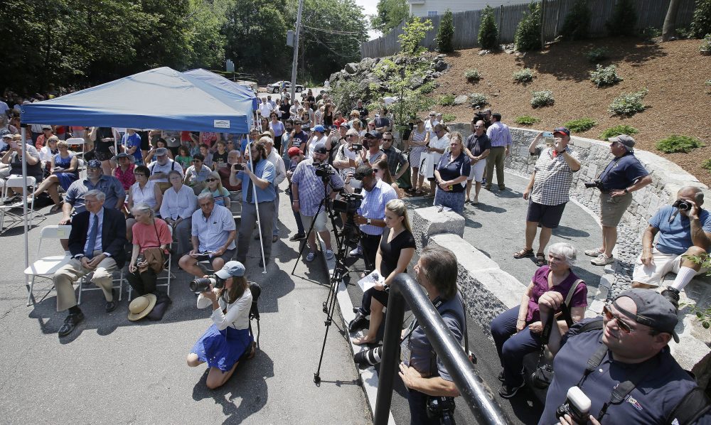 Area residents attend a memorial dedication at Proctor's Ledge in Salem Wednesday.(Stephan Savoia/AP)