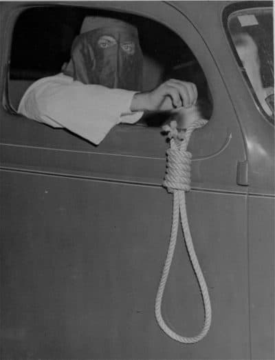 A hangman's noose dangling from an automobile, driven by a hooded Ku Klux Klan member, is among the grim warnings for blacks to stay away from the voting places in the municipal primary election at Miami, Florida, May 3, 1939. In spite of the threats, 616 blacks voted. (AP Photo)