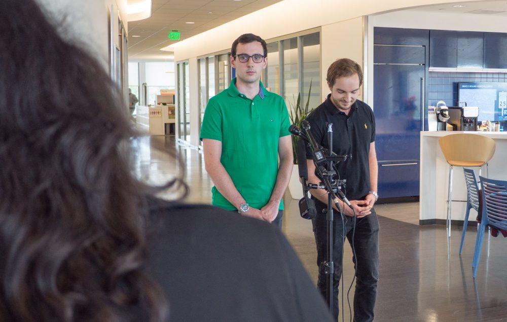 Arthur Delarue, left, and Sebastien Martin speak to reporters at BPS headquarters in Roxbury. (Max Larkin/WBUR)