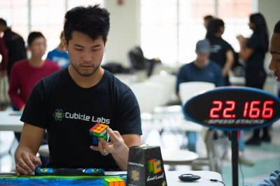 In addition to engineering speedcubes, Chris Tran has competed in many a speedcubing event. Here, he solves the cube one-handed. (Courtesy Chris Tran)