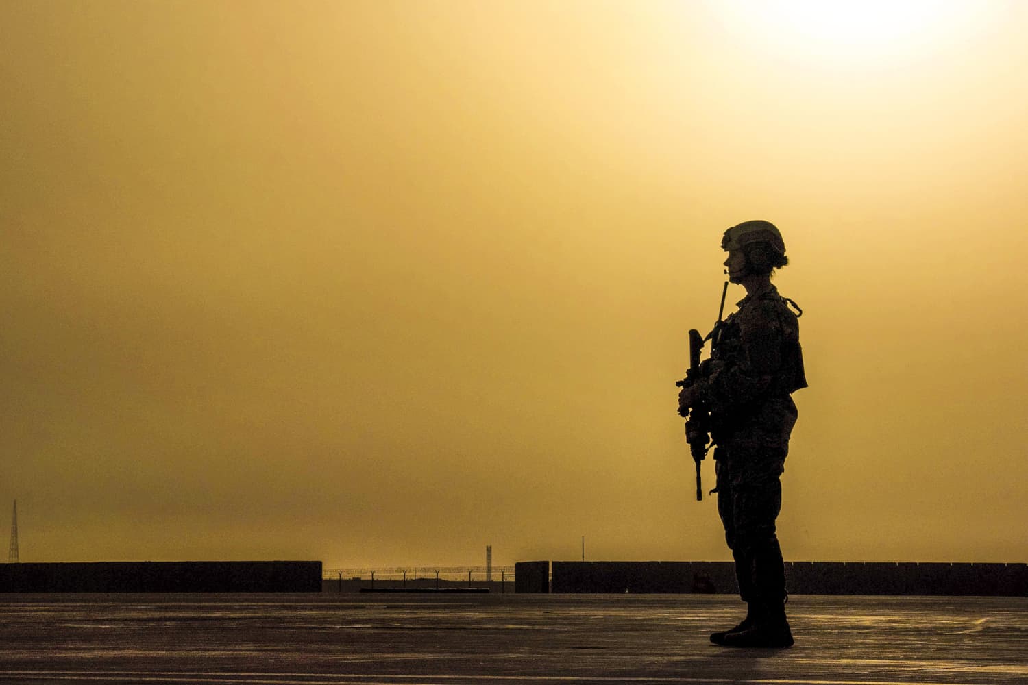 Air Force Airman 1st Class Alexandra Powell scans an airfield for potential threats while a C-130J Super Hercules aircraft transfers equipment and personnel on Camp Shorabak, Afghanistan, March 16, 2016. (Air Force photo by Tech. Sgt. Robert Cloys)