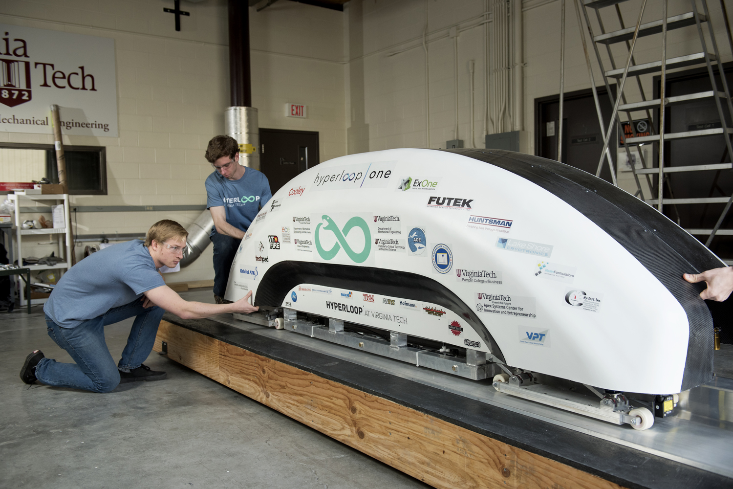 Hyperloop at Virginia Tech team with the final pod they have built for the competition at SpaceX. (Courtesy Virginia Tech College of Engineering)