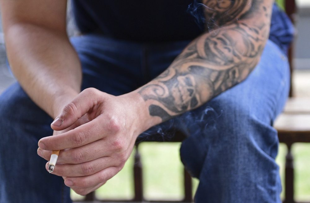 With addiction such a prominent problem, experts say it's time to use words that don't carry judgement. Pictured: A man smokes a cigarette at the Neil Kennedy Recovery Clinic in Youngstown, Ohio. (David Dermer/AP)