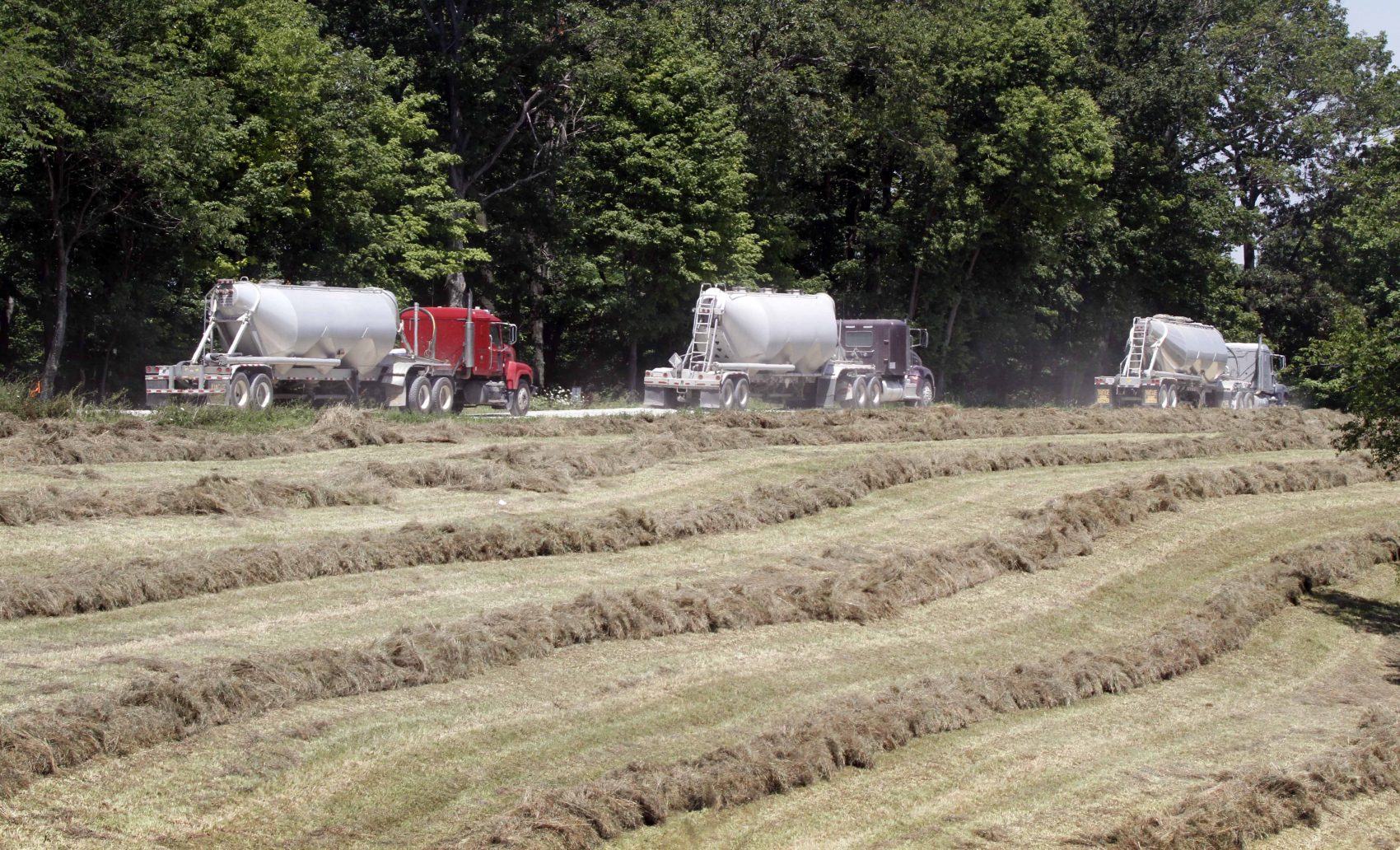 In this photo made on Wednesday, July 27, 2011, a caravan of tanker trucks take away the water mixture used in the hydraulic fracturing process in the Marcellus Shale layer to release natural gas was underway at a Range Resources site in Claysville, Pa. (Keith Srakocic/AP)
