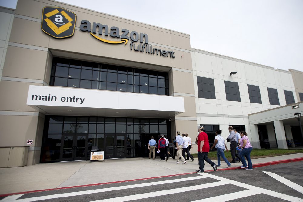 A group of Amazon job seekers enter the company's Fall River fulfillment center during Wednesday's job fair. (Jesse Costa/WBUR)
