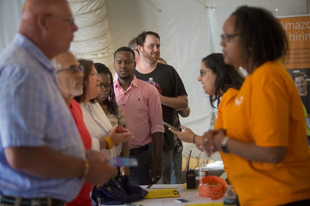 People line up to sign up for tours of Amazon's Fall River warehouse during a job fair Tuesday. (Jesse Costa/WBUR)