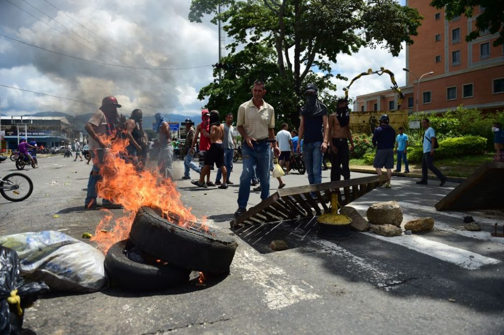 Anti-government activists set up a barricade in the streets of Venezuela's third city, Valencia, on Aug. 6, 2017, a day after a new assembly with supreme powers and loyal to President Nicolas Maduro started functioning in the country. In a video posted online earlier, allegedly at an army base used by the National Bolivarian Armed Forces in Valencia, a man presenting himself as an army captain declared a &quot;legitimate rebellion ... to reject the murderous tyranny of Nicolas Maduro&quot; and demanded a transitional government and &quot;free elections.&quot; After the video surfaced, military chiefs said troops had put down the &quot;terrorist&quot; attack. (Ronaldo Schemidt/AFP/Getty Images)
