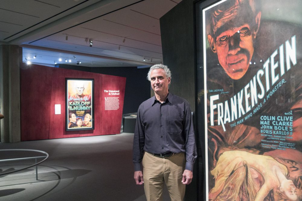 Peabody Essex Museum curator Daniel Finamore usually works with maritime art, but he was taken by Kirk Hammett's vast collection of rare horror and sci fi posters. (Andrea Shea/WBUR)