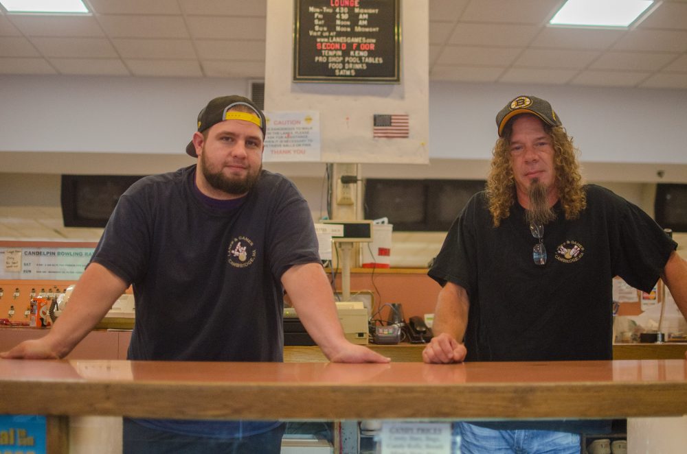 Craig Leverone (left) has worked at Lanes and Games for seven years. Brian Kennedy (right) has worked there for nine years. Long-time customers sing the praises of the staff, saying they make the experience feel more like a fun family hangout than a business transaction. (Sharon Brody/WBUR)