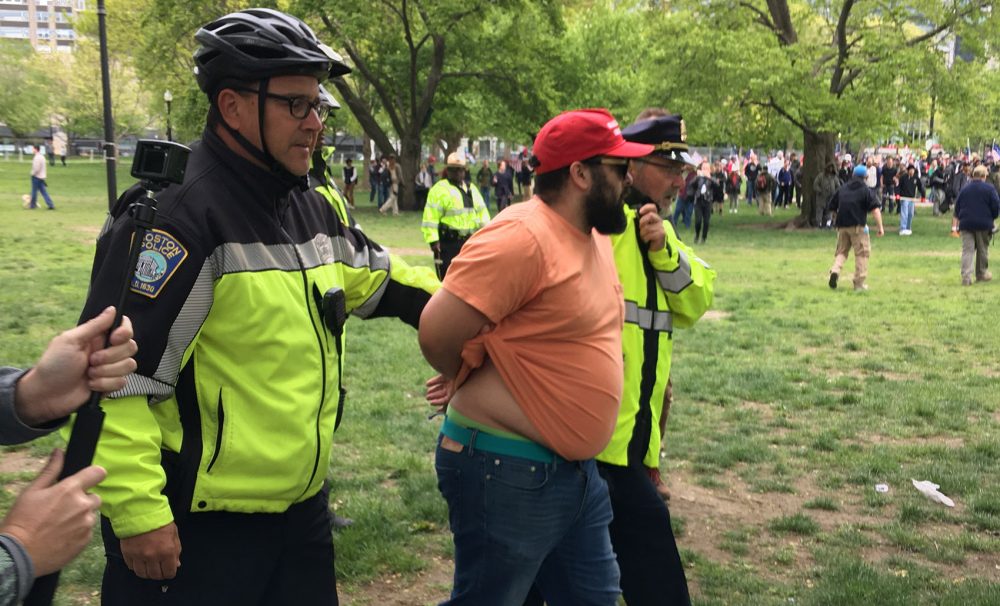 Boston Police arrest a demonstrator after a scuffle at rally on Boston Common in May. (Max Larkin/WBUR)