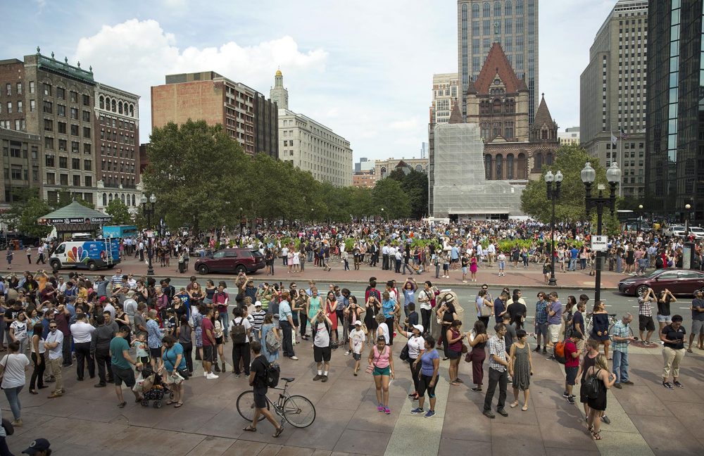 People gather in Copley Square to view the partial solar eclipse in Boston. (Robin Lubbock/WBUR)