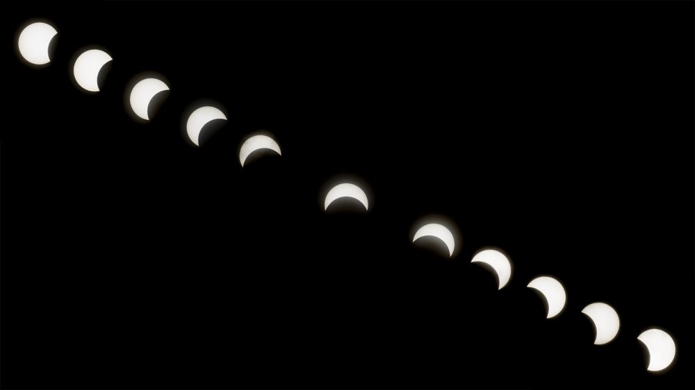 The phases of the partial solar eclipse viewed from Copley Square in Boston. (Jesse Costa/WBUR)