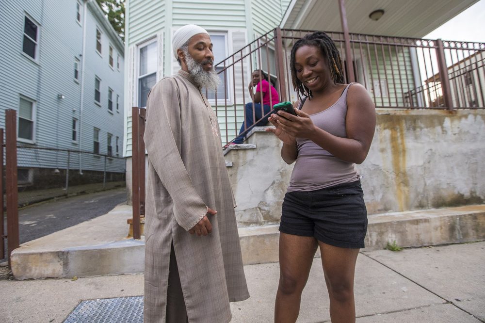 Abdurrashid catches up with Shanna Jackson, a former student at College Bound during a canvass through the Bowdoin-Geneva area. (Jesse Costa/WBUR)