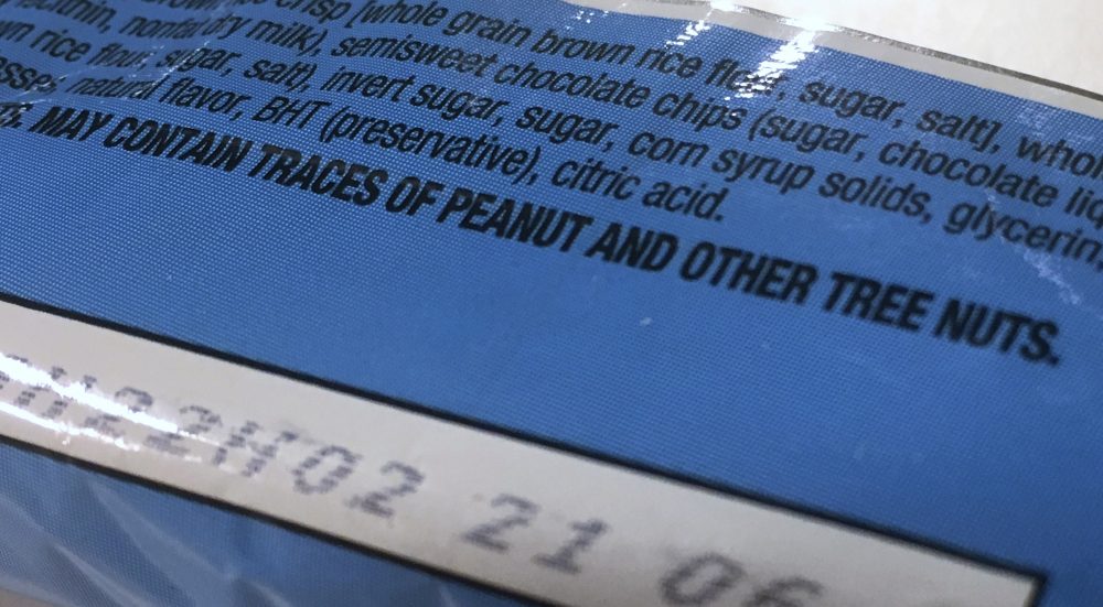 This Nov. 30, 2016, photo shows part of a food label that states the product &quot;may contain traces of peanut and other tree nuts&quot; as photographed in Washington. (Jon Elswick/AP)
