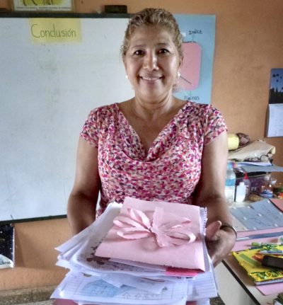 Lempira Elementary School teacher Miriam Avila displays her students' letters. (Karyn Miller-Medzon/Here &amp; Now)