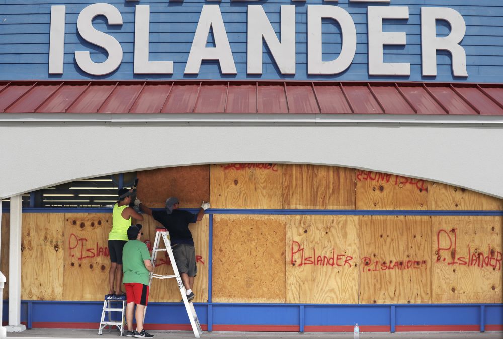 Workers cover a business with plywood in preparation for Hurricane Harvey, Thursday, Aug. 24, 2017, in Corpus Christi, Texas. (Eric Gay/AP)