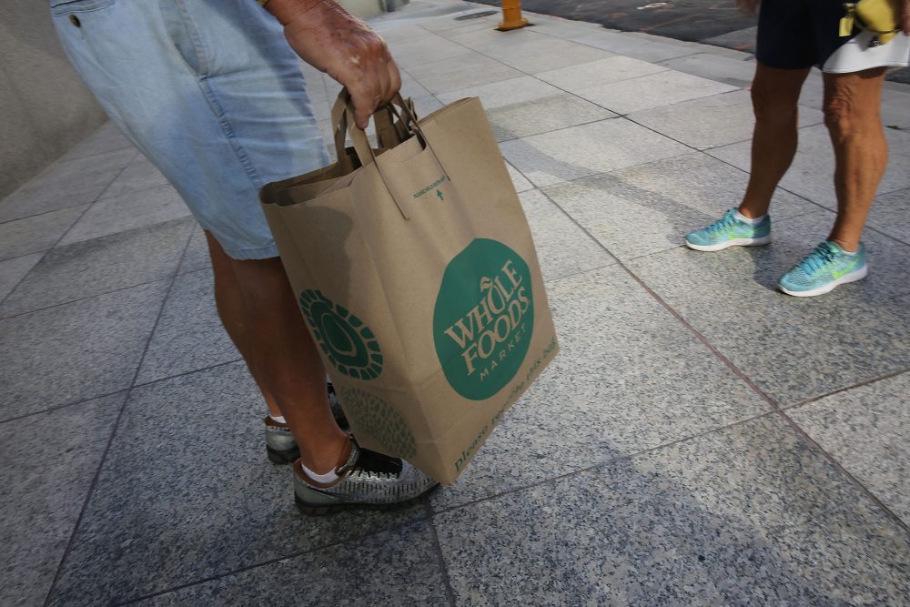 A customer carries his Whole Foods Market bag on May 10, 2017 in Miami. (Joe Raedle/Getty Images)