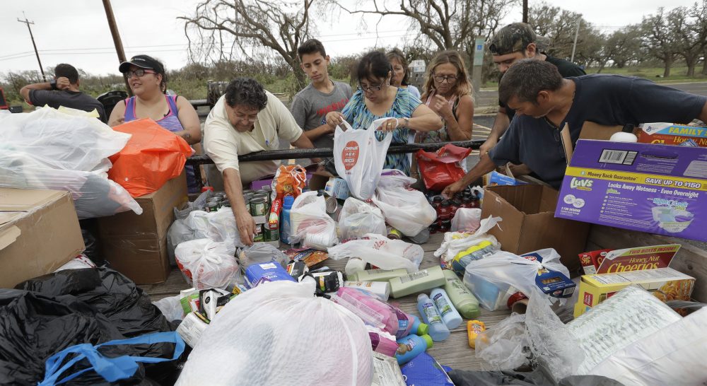 Residents pick through needed items at a make-shift aid station on Sunday in Rockport, Texas. A group from the Texas Rio Grande Valley created station for those in need following Hurricane Harvey. (Eric Gay/AP)