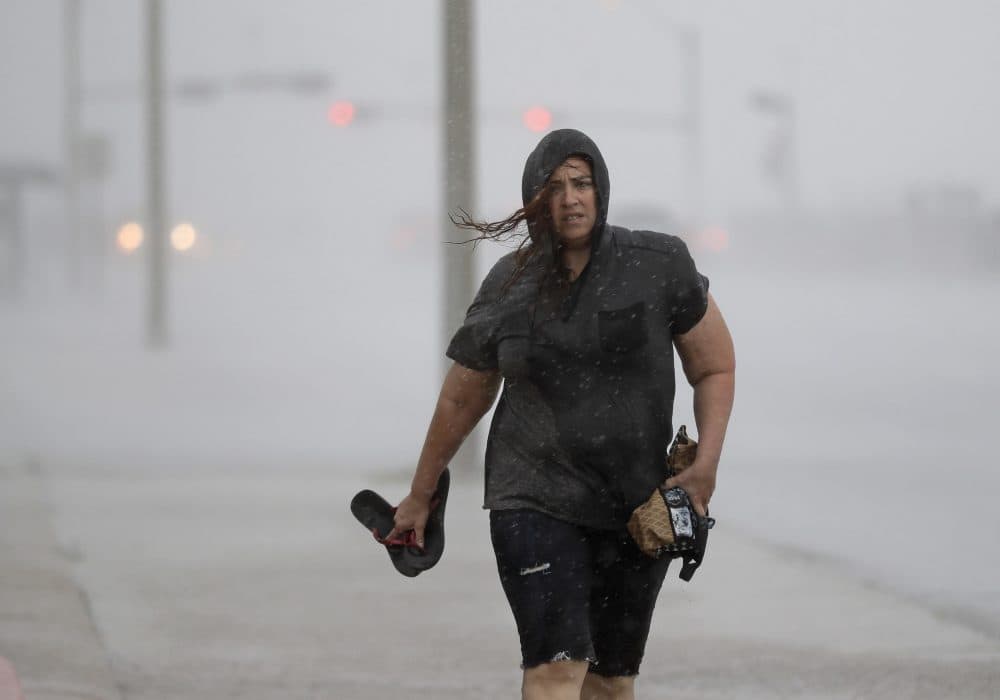 Hillary Lebeb walks along the seawall in Galveston, Texas as Hurricane Harvey intensified in the Gulf of Mexico on Friday. (David J. Phillip/AP)