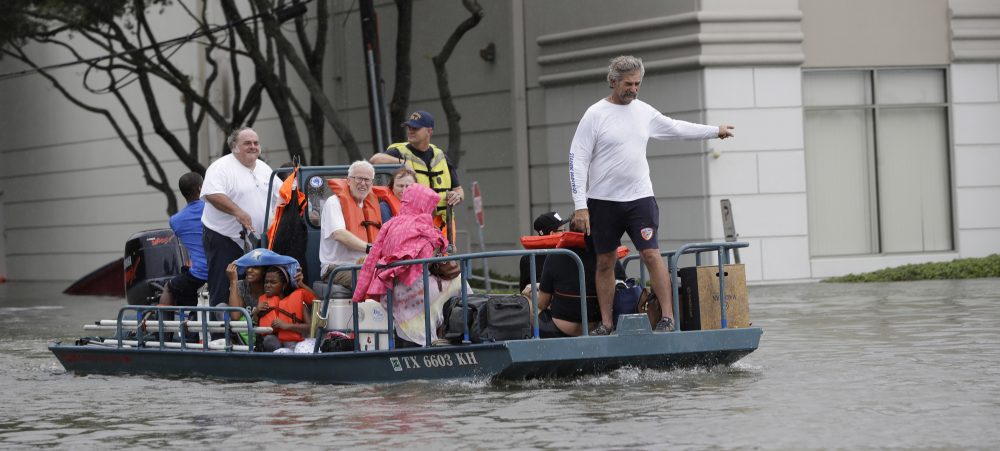 Residents are evacuated from their homes surrounded by floodwaters from Tropical Storm Harvey on Sunday in Houston, Texas. (David J. Phillip/AP)