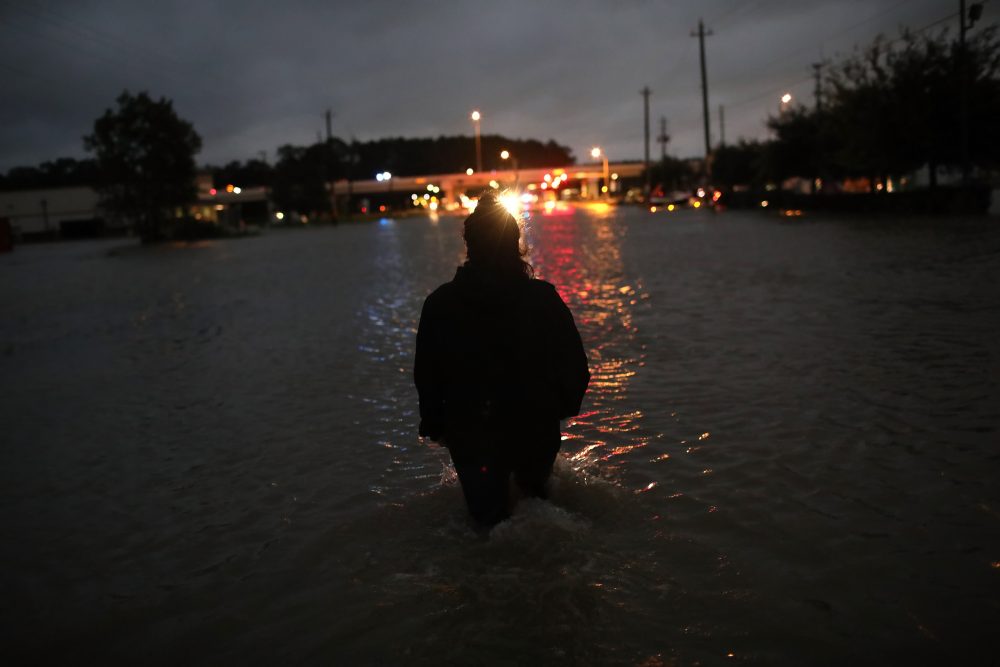 A Houston resident walks through waist deep water while evacuating her home after severe flooding following Hurricane Harvey in north Houston, Aug. 29, 2017. (Win McNamee/Getty Images)