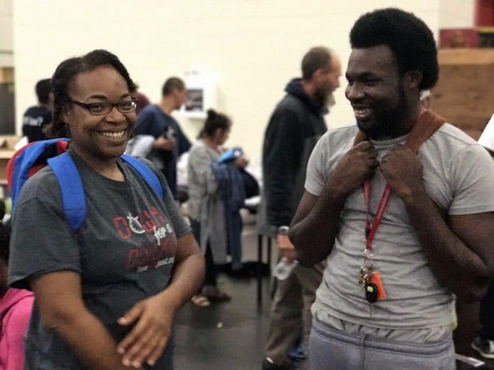 Demetrius Washington and his mother, Ramona, learn that his grandmother is safe Tuesday, Aug. 29 at the George R. Brown Convention Center in Houston. (Rachel Osier Lindley/KERA News)